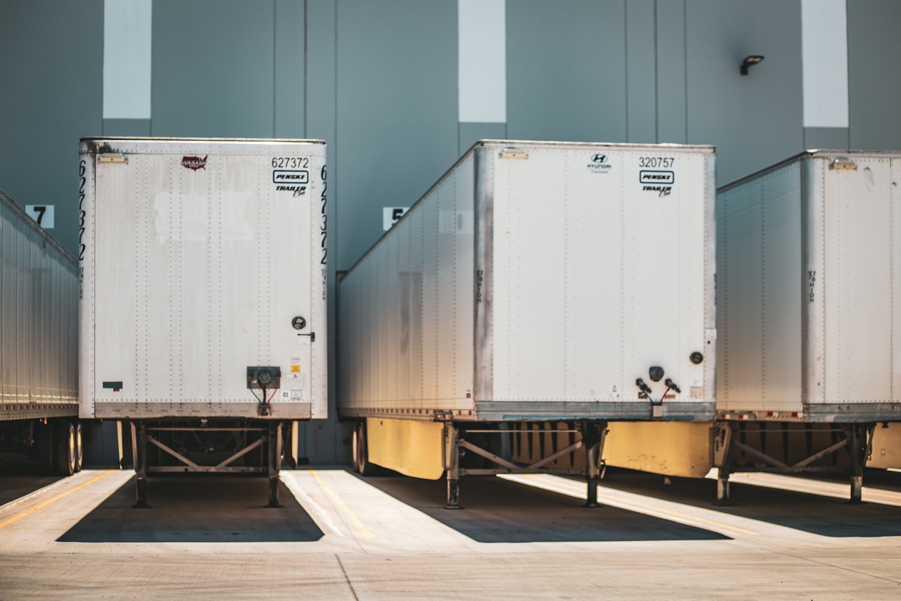 Dry van trailers backed into warehouse loading docks